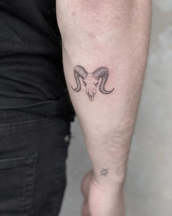 Hình xăm đầu lâu sừng dê trên tay, phong cách blackwork, chi tiết rõ nét, độ phân giải HD.