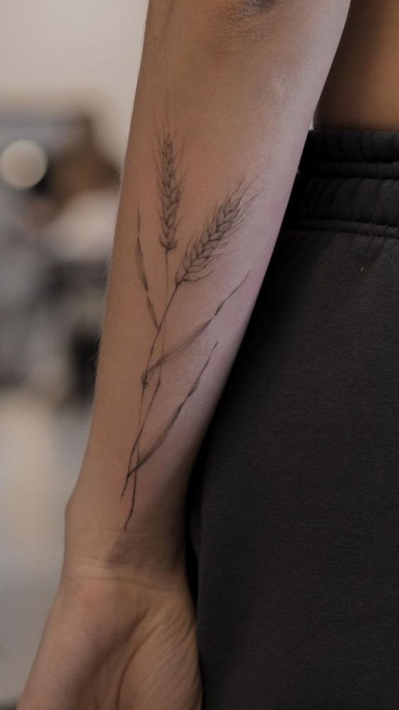Hình xăm bông lúa vintage nhẹ nhàng Hình xăm bông lúa trên cánh tay, phong cách blackwork, chi tiết tinh tế, độ phân giải HD.