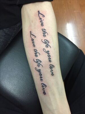 Hình xăm chữ trên cẳng tay, phong cách cổ điển, độ phân giải HD, dòng chữ "Live the life you love."