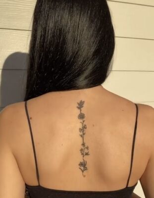Hình xăm hoa đen trắng chạy dọc sống lưng, phong cách blackwork, độ chi tiết cao, ảnh HD.