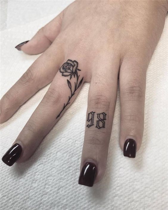 Hình xăm hoa hồng và số trên ngón tay, phong cách blackwork, chi tiết rõ nét, độ phân giải HD.