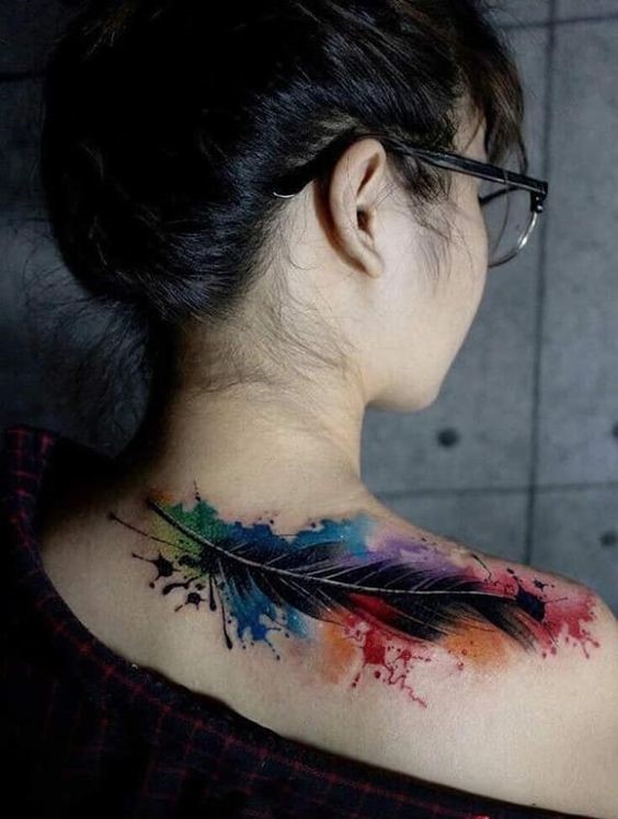 Hình xăm lông vũ màu nước trên vai, phong cách sáng tạo, chi tiết sống động, ảnh độ phân giải cao.