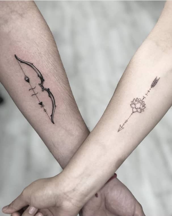 Hình xăm cung và mũi tên hoa sen trên cổ tay, phong cách blackwork, chi tiết rõ nét, độ phân giải HD.
