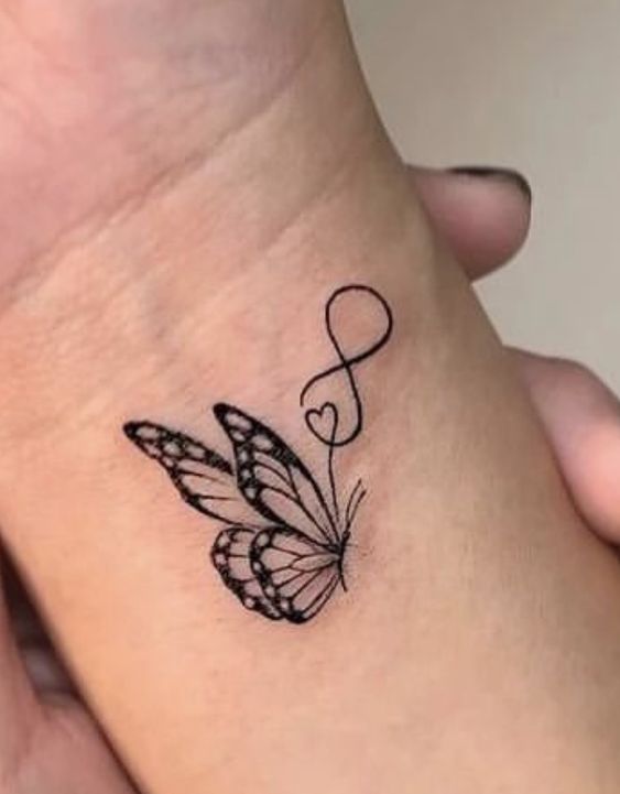 pha trộn cánh bướm và thánh giá Hình xăm bướm mini trên cổ tay, phong cách blackwork chi tiết, độ phân giải HD.
