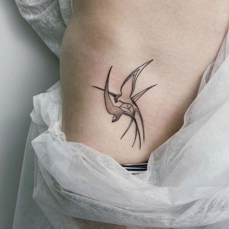 Hình xăm chim én trên hông, phong cách blackwork chi tiết, độ phân giải HD.
