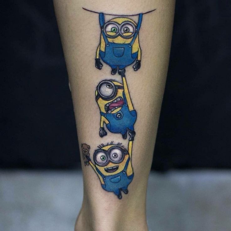 mẫu xăm hình minion cực sinh động Hình xăm nhân vật hoạt hình trên bắp chân, phong cách màu sắc, chi tiết sống động, độ phân giải HD.