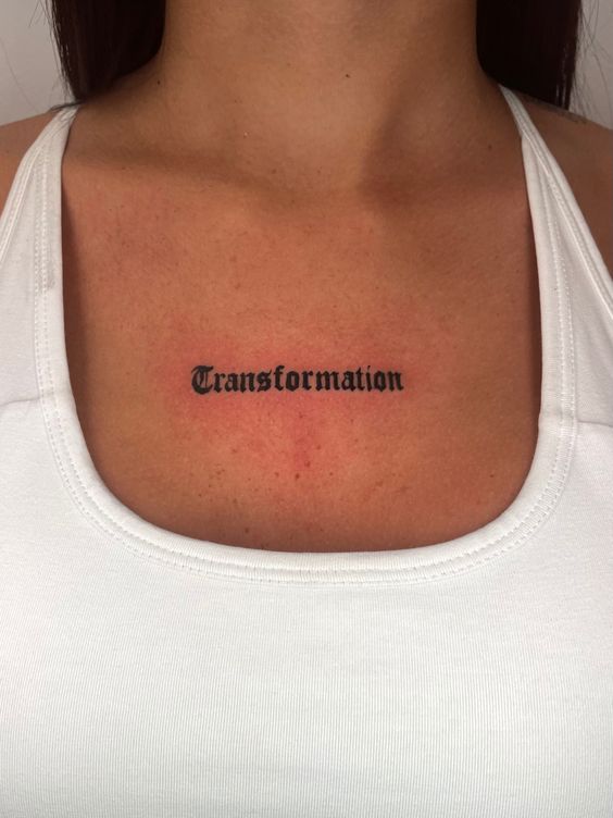 Hình xăm chữ "Transformation" phong cách blackwork trên ngực, chi tiết rõ nét, độ phân giải HD.