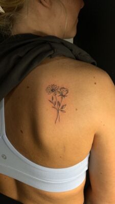 Hình xăm hoa nhỏ trên vai, phong cách blackwork, ảnh chất lượng HD.