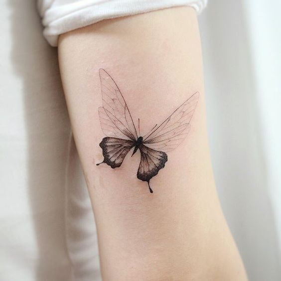 Hình xăm bướm phong cách blackwork trên cánh tay, chi tiết tinh tế, ảnh HD.