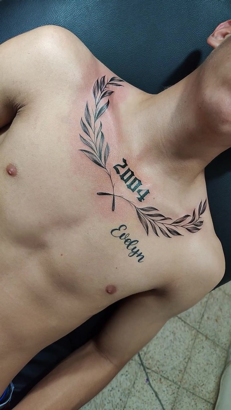 cực phong cách với mẫu tattoo năm sinh Hình xăm chữ và lá ô liu trên ngực, phong cách blackwork, chi tiết rõ nét, ảnh HD.