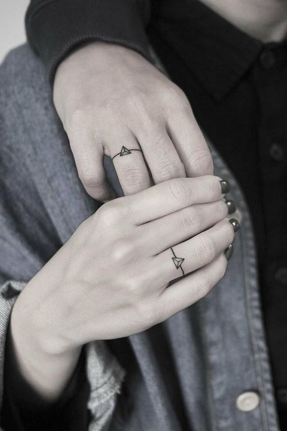 Hình xăm mini hình tam giác trên ngón tay, phong cách blackwork, chi tiết tối giản, ảnh độ phân giải HD.