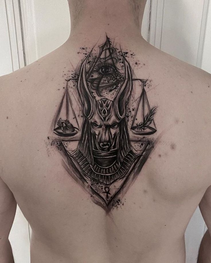 Hình xăm Anubis trên lưng, phong cách blackwork chi tiết, độ phân giải HD.