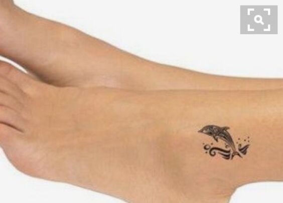 Hình xăm cá heo mini vượt sóng Hình xăm cá heo mini trên mắt cá chân, phong cách blackwork, ảnh HD chi tiết.