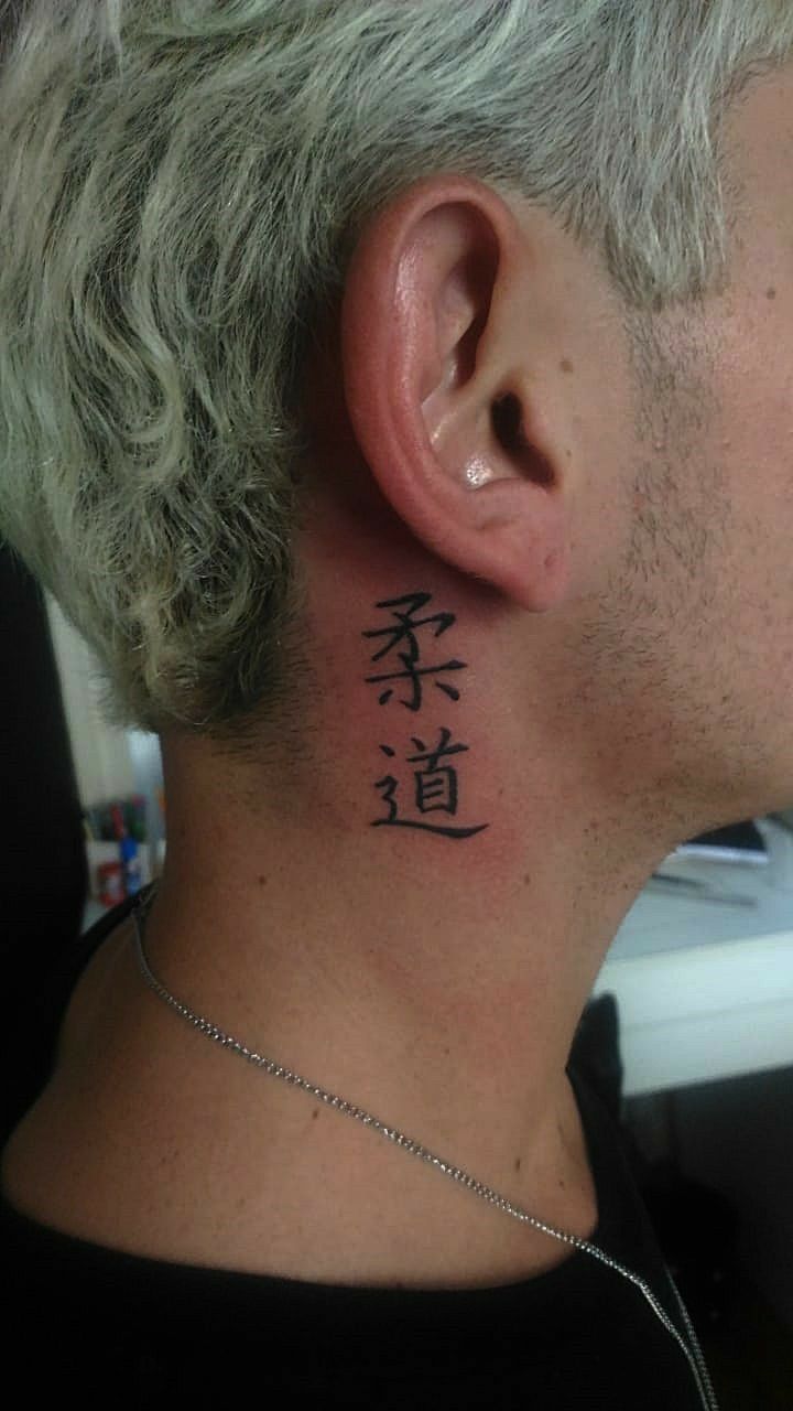 Hình xăm chữ Nhật sau tai, phong cách blackwork, độ phân giải HD, chi tiết sắc nét.