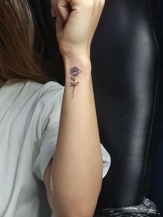 hình xăm hoa hồng đen đơn giản Hình xăm hoa hồng mini trên cổ tay, phong cách blackwork, chi tiết rõ nét, ảnh HD.