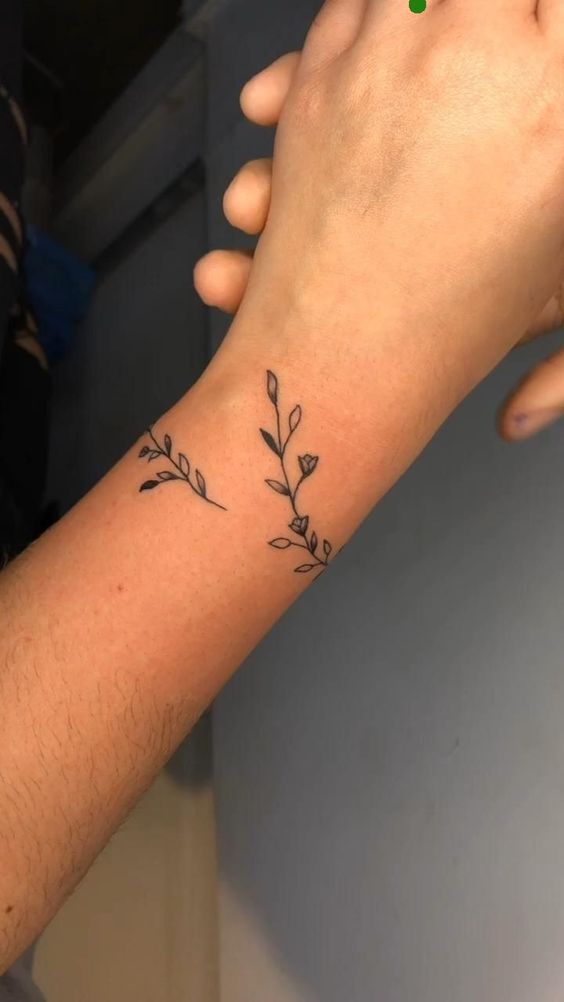 Hình xăm nhánh cây mini trên cổ tay phong cách blackwork, chi tiết rõ nét, độ phân giải cao.