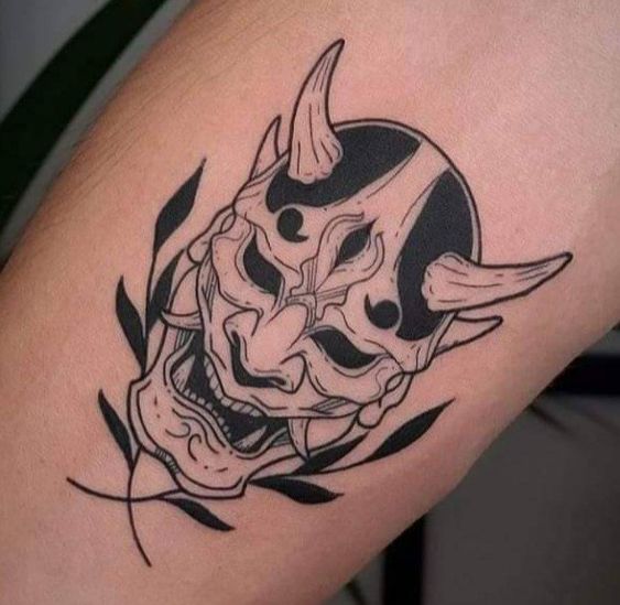 Hình xăm mặt nạ Oni trên tay, phong cách blackwork, chi tiết rõ nét, ảnh HD.