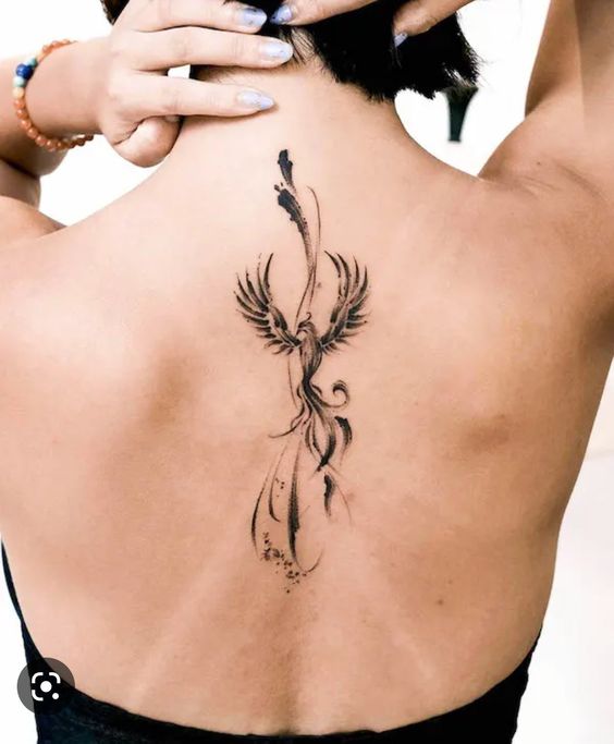 Hình xăm phượng hoàng trên lưng, phong cách blackwork, chi tiết tinh tế, ảnh độ phân giải cao.