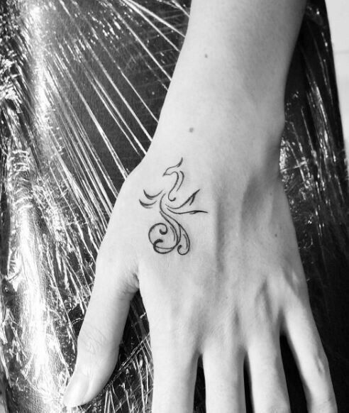Hình xăm mini hình phượng hoàng trên mu bàn tay, phong cách blackwork, ảnh trắng đen HD.