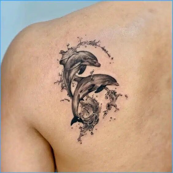 Hình xăm đôi cá heo ngọt ngào Hình xăm cá heo trên vai, phong cách blackwork chi tiết, độ phân giải HD.