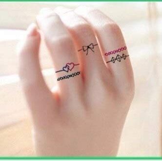 Trang trí ngón tay bằng họa tiết nơ Hình xăm mini trên ngón tay, phong cách đường nét đơn giản, độ phân giải HD.