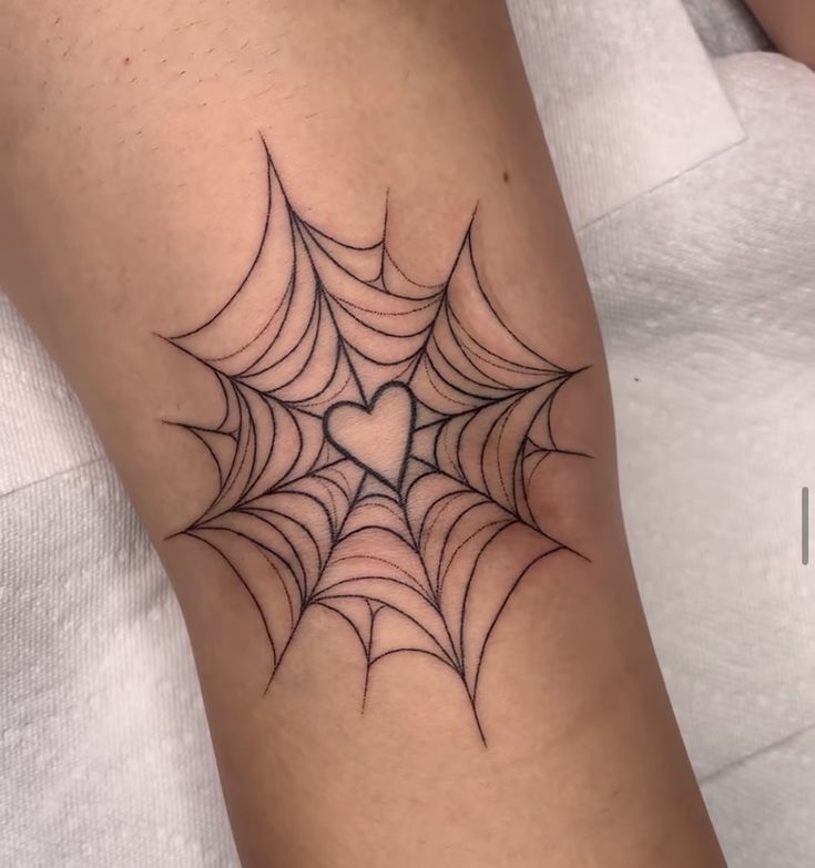 Hình xăm mạng nhện có hình trái tim, vị trí cánh tay, phong cách blackwork, chi tiết rõ nét, độ phân giải HD.