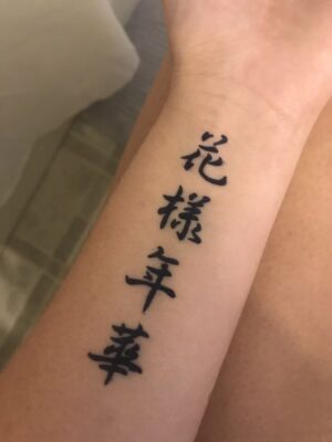 hình xăm chữ Tàu có ý nghĩa Hình xăm chữ Hán cổ điển trên cánh tay, phong cách blackwork, chi tiết rõ nét, ảnh HD.