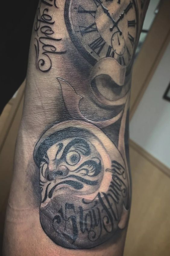 Mẫu xăm daruma theo yêu cầu cho khách hàng nam Hình xăm đồng hồ cổ điển trên tay, phong cách blackwork, chi tiết sắc nét, độ phân giải HD.