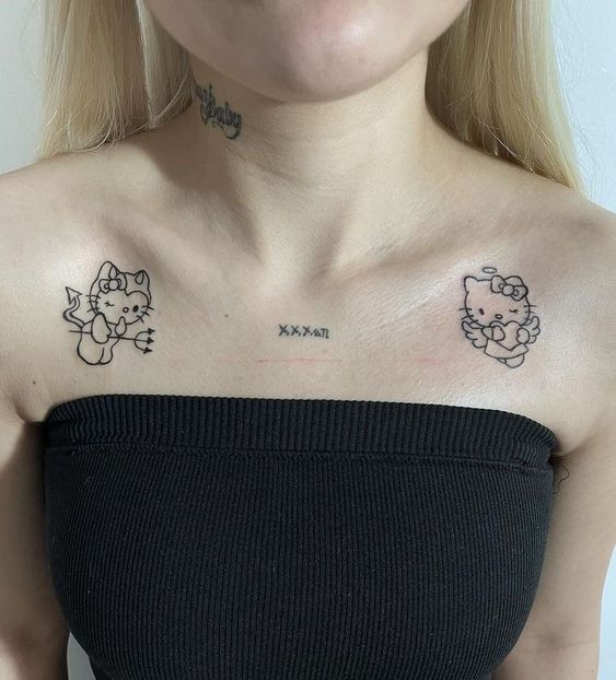 Hình xăm mèo hoạt hình phong cách blackwork trên vai, ảnh HD chi tiết.