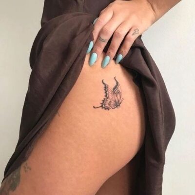 Hình xăm bướm mini trên đùi, phong cách blackwork, chi tiết rõ nét, ảnh độ phân giải HD.