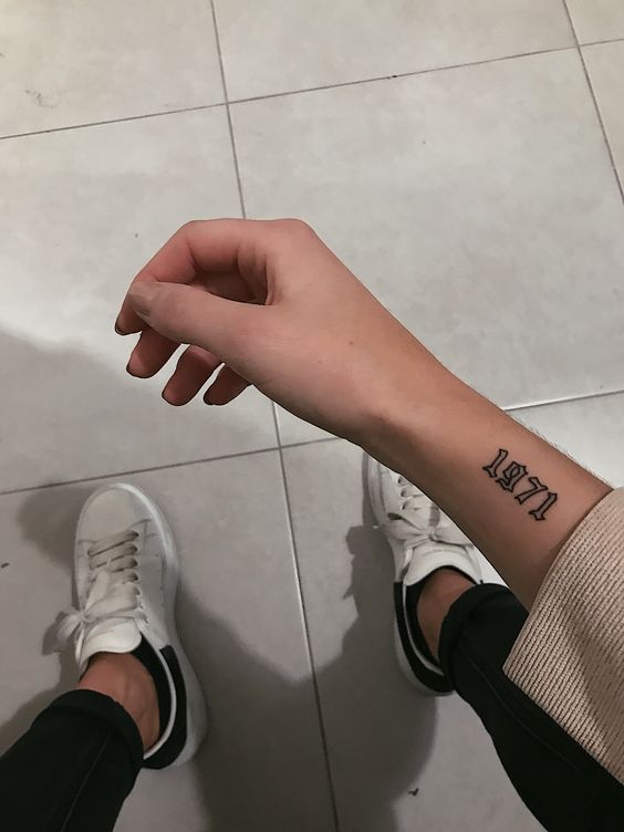 Hình xăm số "1971" trên cổ tay, phong cách blackwork, ảnh chất lượng HD.