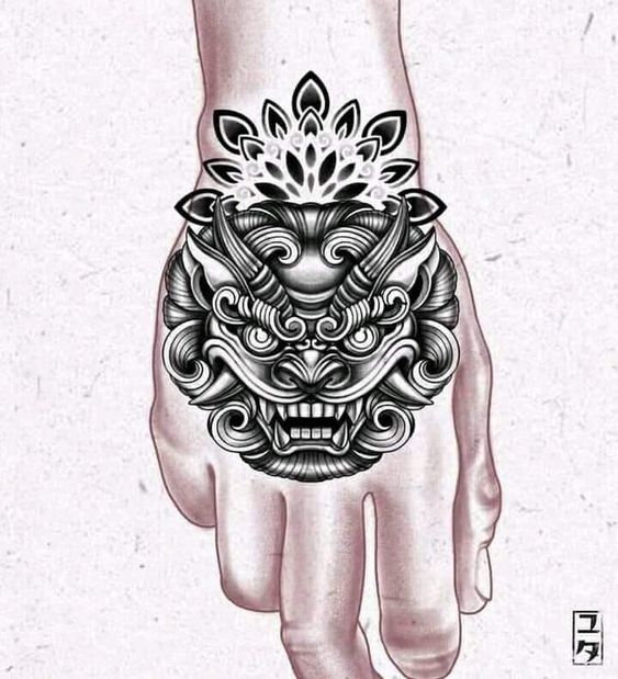 Hình xăm mặt quỷ phong cách blackwork trên mu bàn tay, chi tiết sắc nét, ảnh HD.