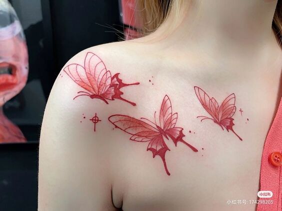Hình xăm bướm đỏ ở vai, phong cách blackwork, chi tiết tinh tế, độ phân giải HD.