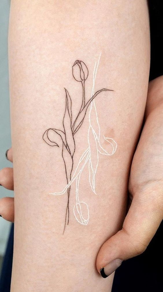 Hình xăm hoa tulip phong cách blackwork trên cánh tay, chi tiết tinh tế, ảnh HD.