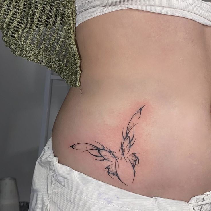 Hình xăm cách điệu tinh tế cho khách Hình xăm bướm cách điệu trên eo, phong cách blackwork, độ chi tiết cao, ảnh HD.