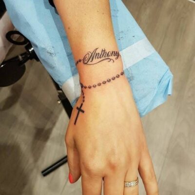 Hình xăm chữ và chuỗi hạt cổ tay phong cách blackwork, chi tiết rõ nét, độ phân giải HD.