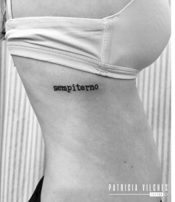 Hình xăm chữ "sempiterno" nhỏ trên mạn sườn, phong cách blackwork, ảnh đen trắng, độ phân giải HD.