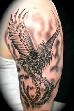 tattoo phượng hoàng lửa đơn sắc của chị khách Hình xăm phượng hoàng trên bắp tay, phong cách blackwork chi tiết, độ phân giải HD.