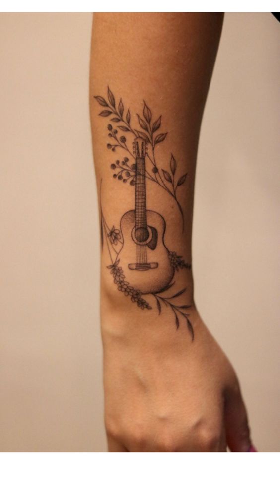 Hình xăm đàn guitar và lá, vị trí cổ tay, phong cách blackwork, chi tiết tinh tế, ảnh HD.